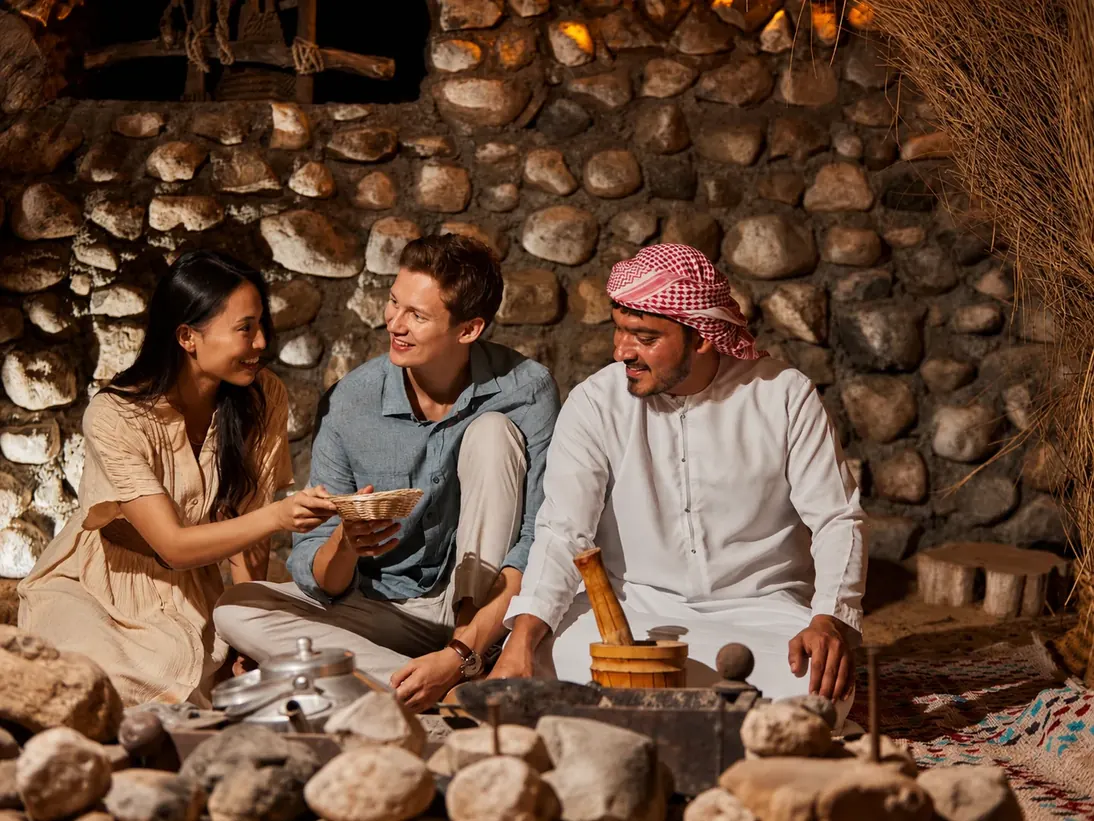 Guests enjoying traditional Emirati hospitality at a Dubai desert camp